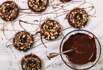 Fresh baked gluten free chocolate donuts and bowl with glaze