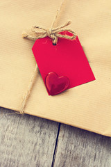 Gift in kraft paper with red card and heart