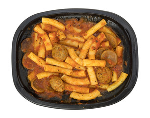 Rigatoni pasta with meatballs and sausage TV dinner top view isolated on a white background.