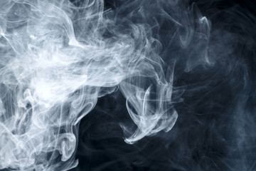 Abstract smoke Weipa. Personal vaporizers fragrant steam. The concept of alternative non-nicotine smoking. Blue smoke on a black background. E-cigarette. Evaporator. Taking Close-up. Vaping.
