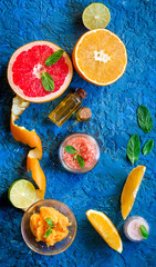 organic cosmetic with citrus on blue background top view