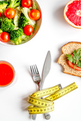 concept slimming diet fresh vegetables on white background top view