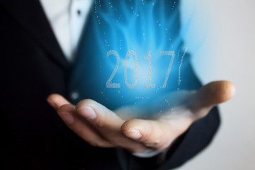 Businessman holding 2017 text