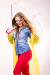 Woman wearing waterproof coat under umbrella