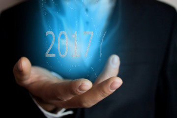 Businessman holding 2017 text
