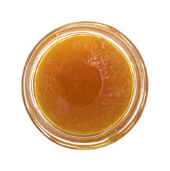Sugar free apricot preserves in an opened jar top view isolated on a white background.