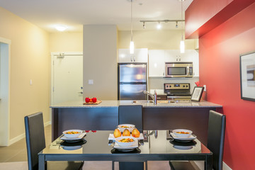 Modern red dining room with kitchen in a luxury apartment. Interior design.