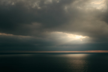 Dramatic sunset over green sea