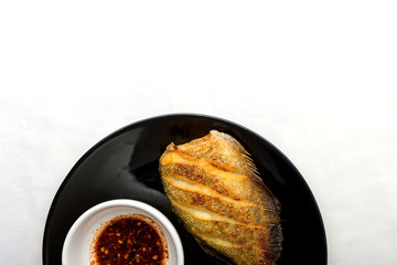 fish fry on black plate ,Trichogaster pectoralis, fish salid.