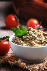 Homemade mustard with seeds in a white bowl, selective focus