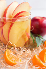 Fresh apple juice in a glass on a background of fruit
