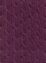 Knitted fabric with a pattern of vertical braids.Decorative material, background, texture, wallpaper