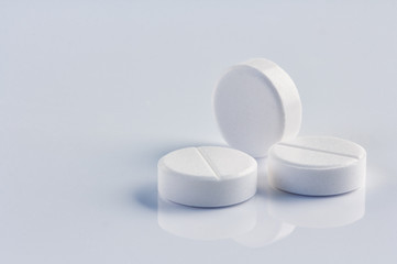 white round pills on the white background