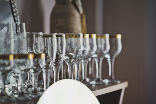 Wine glasses standing in a row on the table 7005.