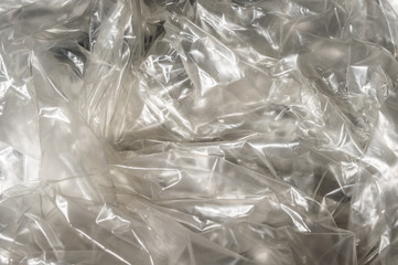 Texture white crumpled cellophane transparent on sunlight. Concept of materials for packaging,...