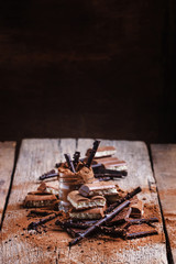 Dark, milk and aerated chocolate with cocoa powder, rustic style