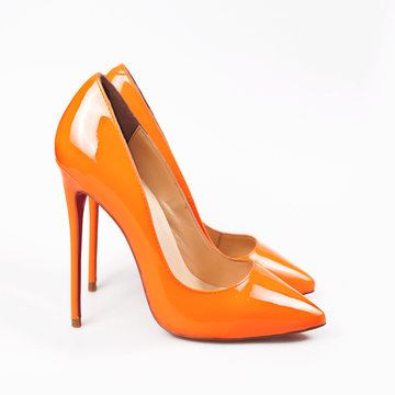 Female orange shoes over white