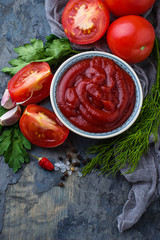 Tomato ketchup sauce on concrete background