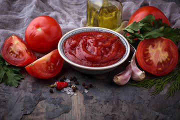 Tomato ketchup sauce on concrete background