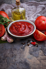 Tomato ketchup sauce on concrete background