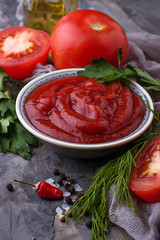 Tomato ketchup sauce on concrete background