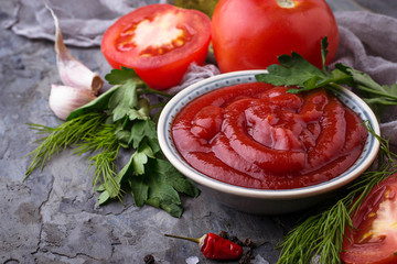 Tomato ketchup sauce on concrete background