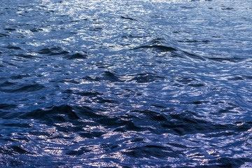 View of a Crystal clear sea water texture. View from above Natural blue background. Turquoise ripple water reflection in tropical beach. Blue ocean wave. Summer sea. Top view