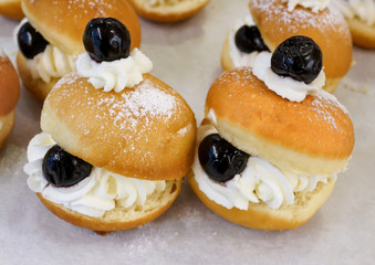Close up of fresh donuts with cherry on bakery display for Hanukkah celebration. Selective focus.