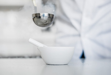 Laboratory technician performs an experiment with liquid nitroge