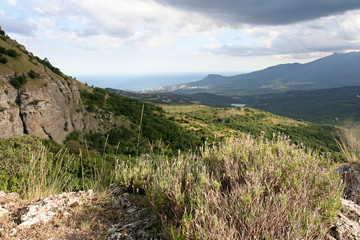 The landscape with the wild lavender, white limestone rocks and mountains lightened by sunshine. This photo was taken in Crimean Mountains, on Demerdzhi mountain.
