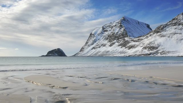 Waves at Haukland beach in the Lofoten archipel in Norway during a beautiful winter day.