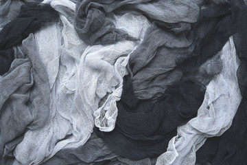 Hand dyed pastel colored gauze fabric in gray .