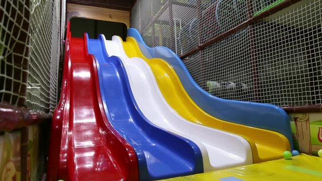 A girl riding with children's slides at an entertainment park
