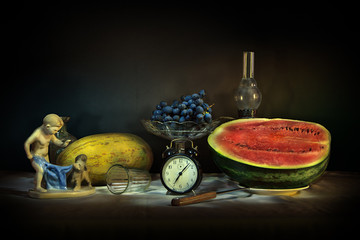 Still life with vintage objects, melon and watermelon