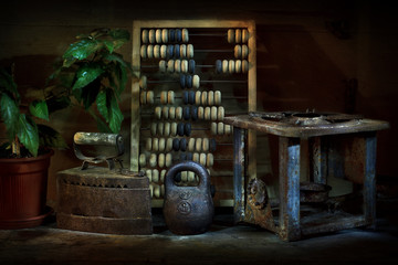 Still life with vintage objects. Iron, scores, weight, primus