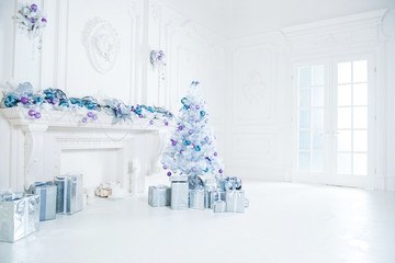 Christmas tree with presents underneath in living room