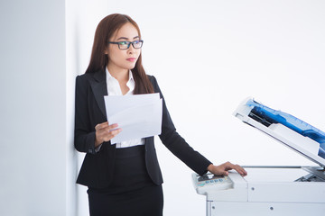 Pensive Business Woman at Copier with Document