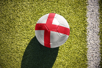 football ball with the national flag of englandlies on the field