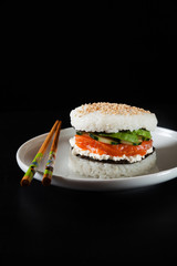 sushi plate with burger made from rice and smoked salmon, avocad