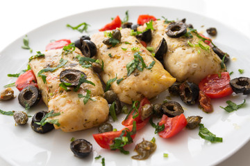 Filetti di merluzzo alla mediterranea, boiled cod fillets with black olives, capers and tomatoes