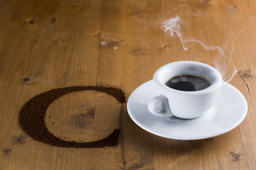 small cup reversed with coffee beans scattered on the wooden table
