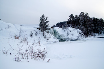 Winter waterfall near the lake