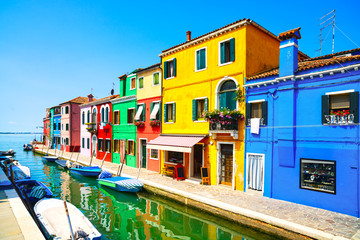 Fototapeta na wymiar Venice landmark, Burano island canal, colorful houses and boats.