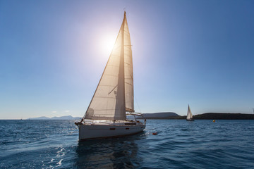 Sailing in the wind through the waves at the Aegean Sea. Luxury yachts.