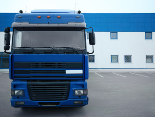 Truck on car parking near warehouse. Delivery and shipping concept.