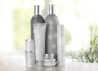 Beauty cosmetic set on table. Snowy effect. Holiday celebration concept.