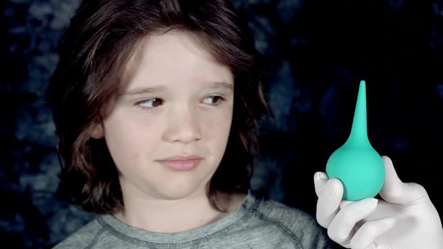 4k Funny Shot of a Child and a Doctor Hand showing Clyster