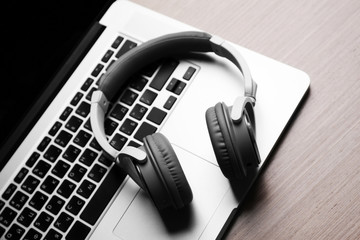 Laptop and headphones on a table, close up