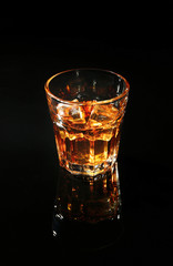 Glass of whisky on dark background