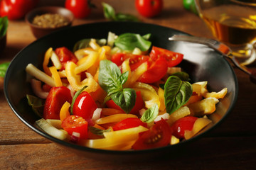 Tasty vegetable salad on kitchen table
